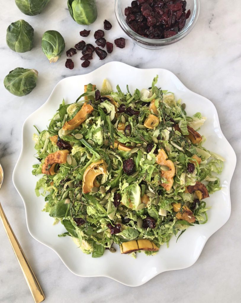Shredded Brussels Sprouts Salad | Chelsey Amer Nutrition Add veggies to your Thanksgiving table! | A hearty combination of sweet and tangy flavors — Brussels sprouts, cranberries, and delicata squash — dressed with honey dijon mustard vinaigrette, finds the perfect home at your Thanksgiving table! Vegan, Gluten Free, Grain Free