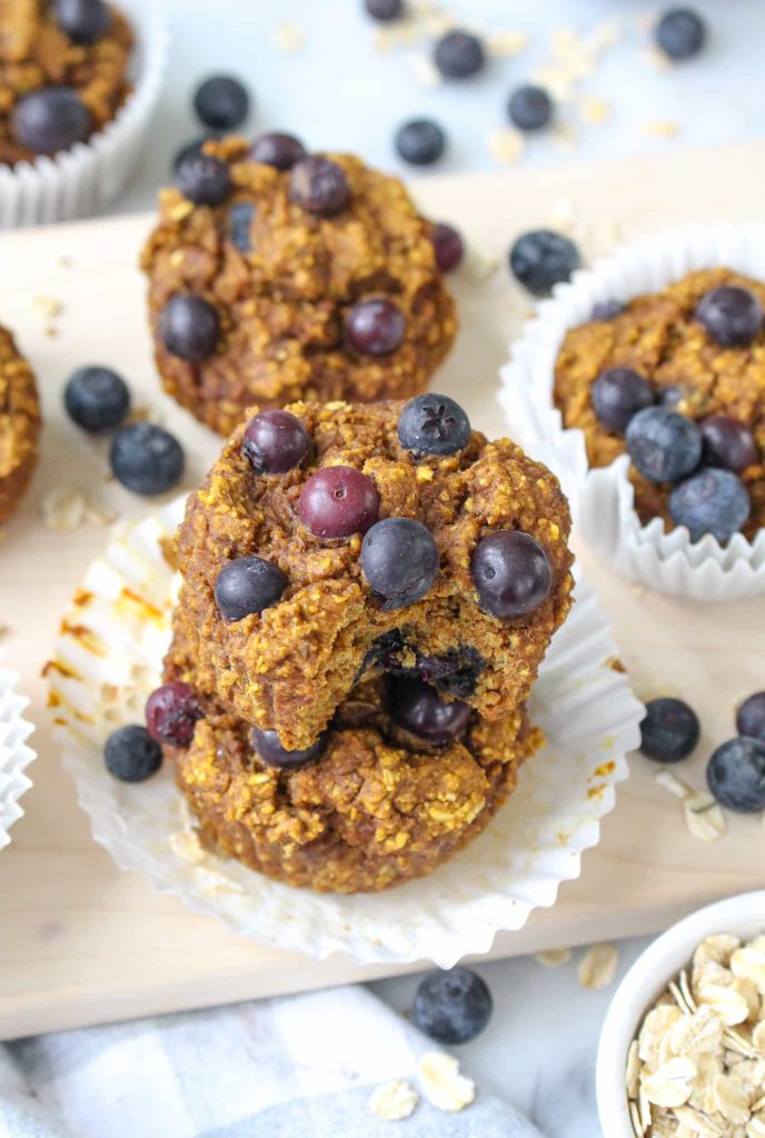 stacked Gluten Free Pumpkin Oatmeal Muffins with blueberries