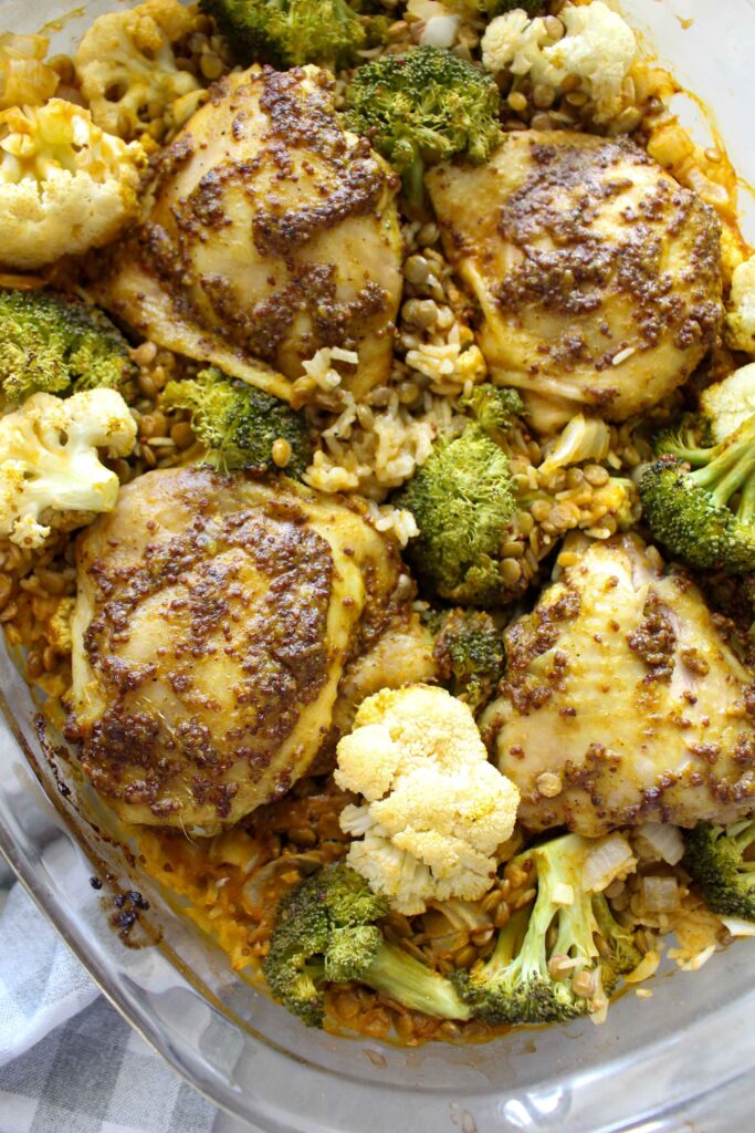 One Pan Honey Mustard Chicken and veggies bakes on a bed of rice and lentils for a simple and healthy weeknight dinner that will feed your whole family in one dish! Customize with whatever veggies your family likes best!
